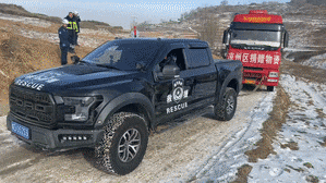 A Ford F-150 Raptor will tow a truck carrying disaster relief supplies out of trouble.
