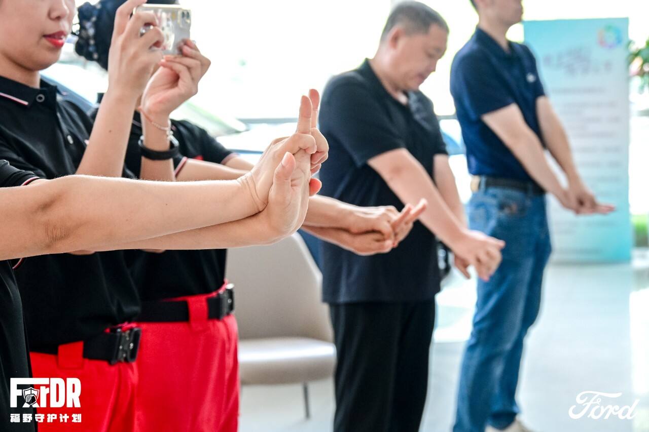 Rescue team instructor guiding participants through CPR practice