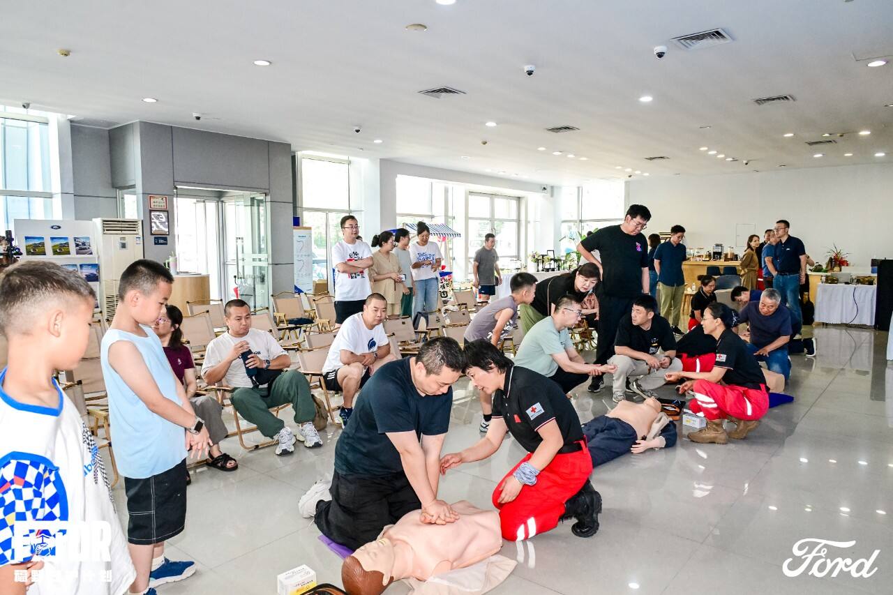 Rescue team instructor guiding participants through CPR practice