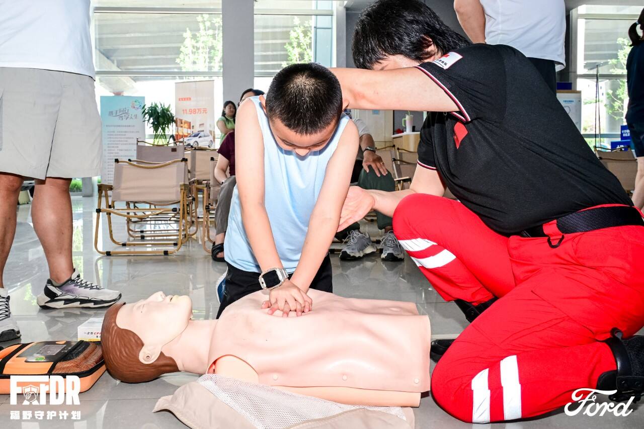 Rescue team instructor guiding participants through CPR practice