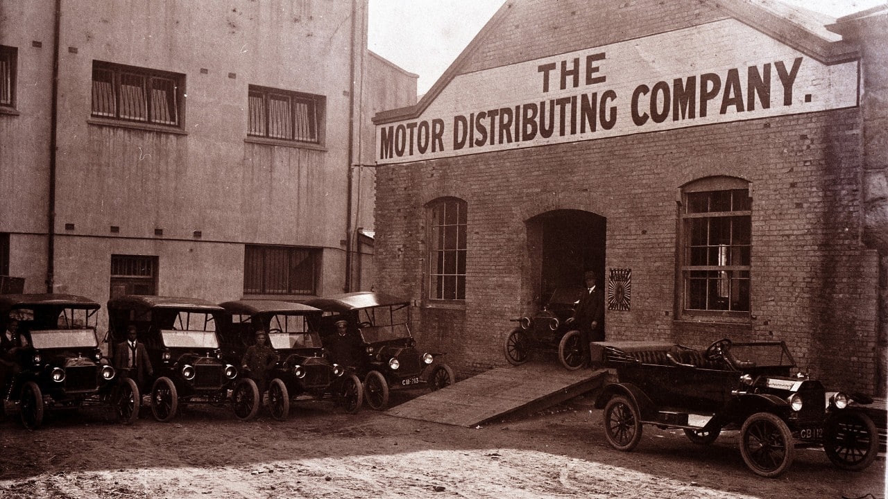 The first Ford vehicles made in South Africa are parked outside the plant.