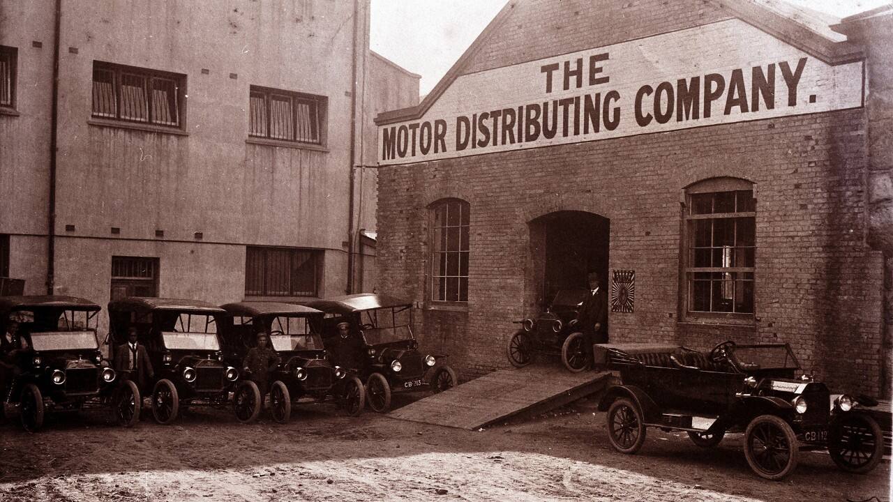 The first Ford vehicles made in South Africa are parked outside the plant.