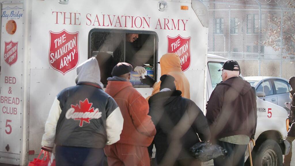 Ford volunteers line up behind a Salvation Army truck.