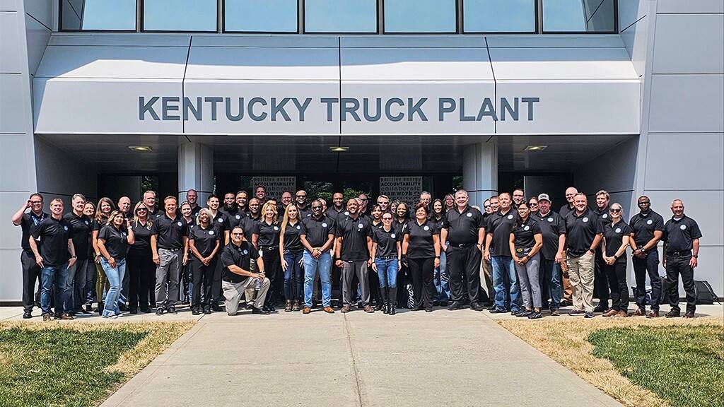 Ford Vice President of Manufacturing and Labor Affairs Bryce Currie stands outside of Kentucky Truck Plant with a group of Ford representatives who participated in the second leg of the FPS Bus Tour, which included visits to Lima Engine Plant, Louisville Assembly Plant, Kentucky Truck Plant and Sharonville Transmission Plant.