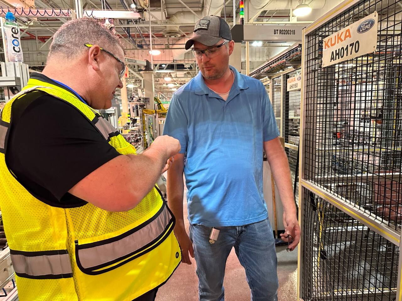 Bryce Currie, vice president of Americas manufacturing and labor affairs, presents an FPS Pin of Excellence to Lima Engine Plant Process Engineer Chris Clement, who previously submitted an idea for a cost-saving project.  