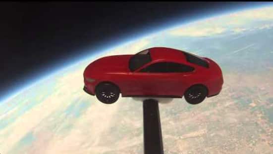 A toy 2015 Ford Mustang floating in space