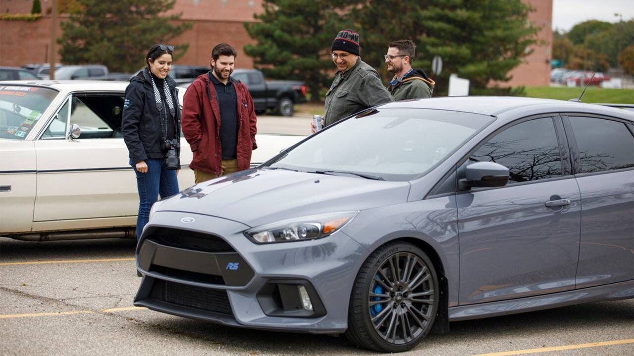 Kapur, who is also interested in sports cars, discuss a Ford Focus RS on display.  