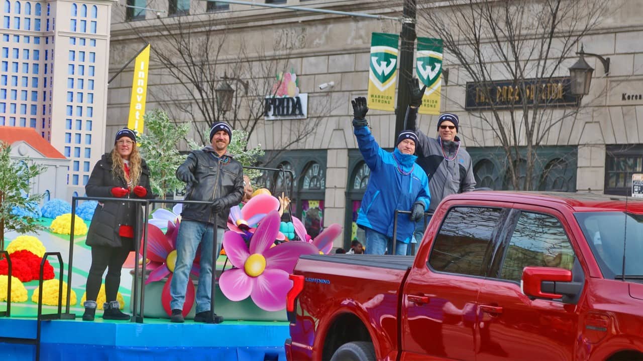 Volunteers ride the finished float in the parade