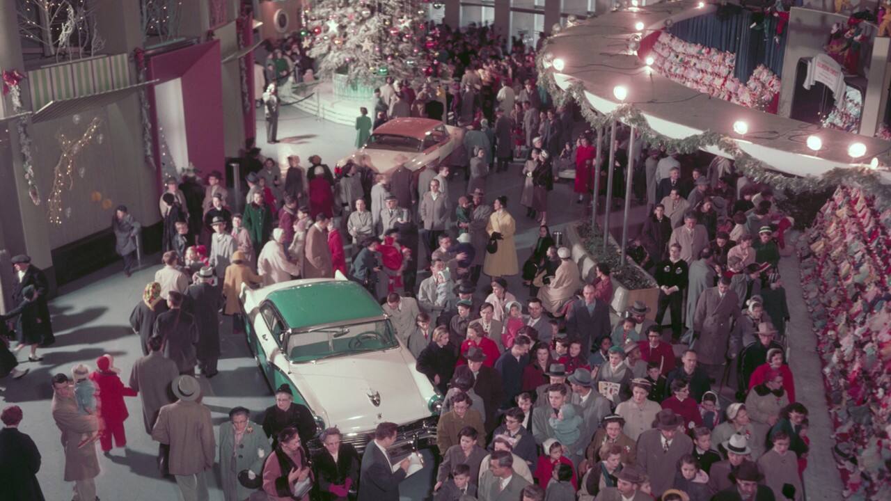 Attendees crowd around a Ford vehicle at the Christmas Fantasy at the Rotunda