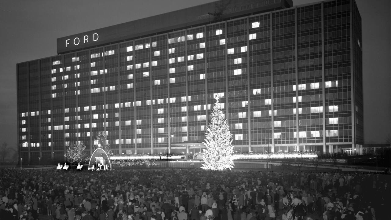 The interior-lit rooms of the World Headquarters spell out "Merry Christmas" on the building's side.