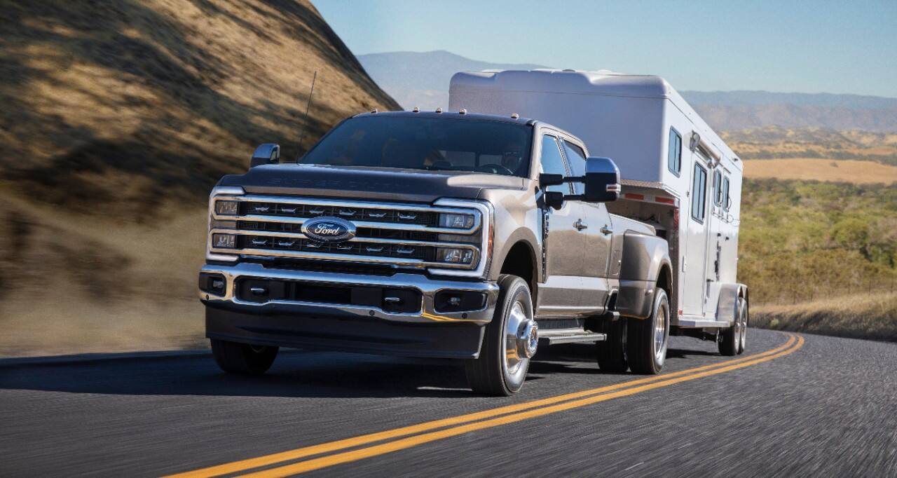 A Super Duty tows a trailer up a road