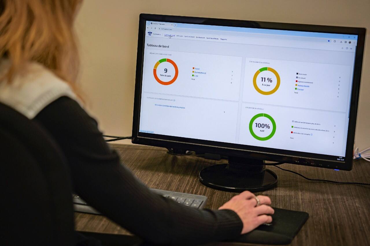 A Fize Electrique employee using Ford Pro E-Telematics on a computer. Ford Pro Telematics is available on vehicles with embedded modem or equipped with plug-in device