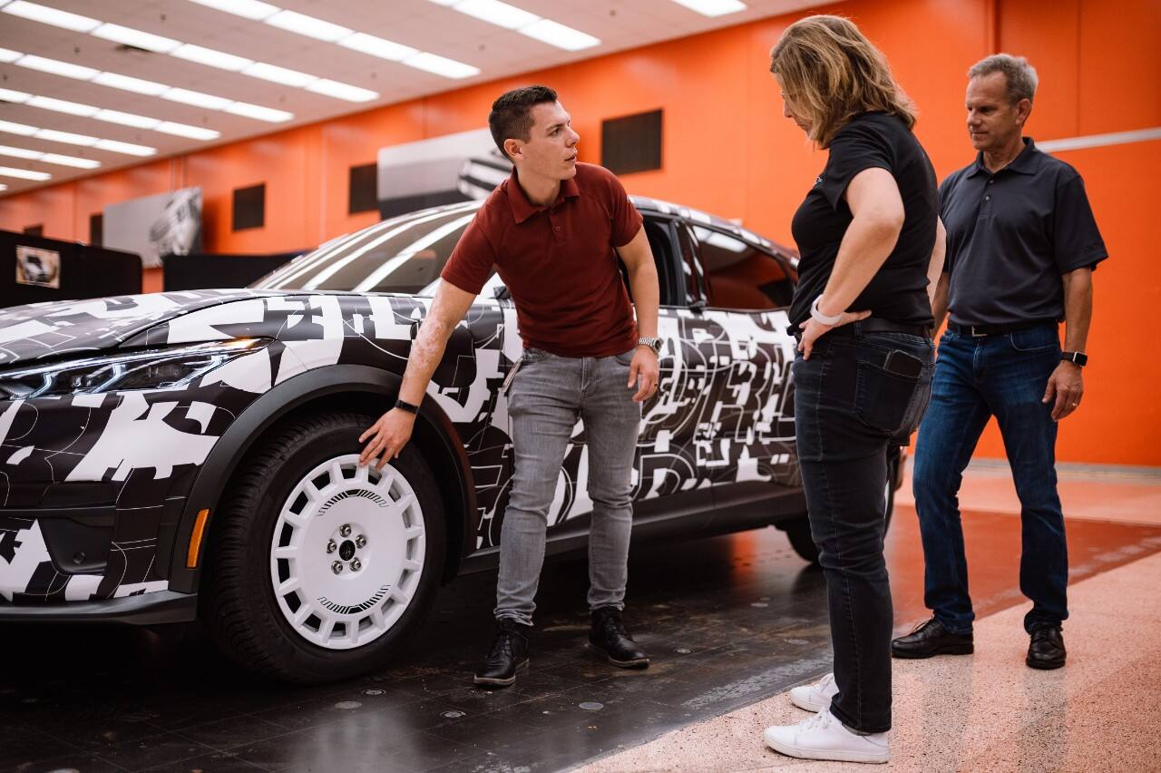 Schultz, now program manager, reviews the new rally-inspired all-electric SUV with Donna Dickson (middle), chief engineer, Mustang Mach-E, and Dave Aucott, technical expert (right).